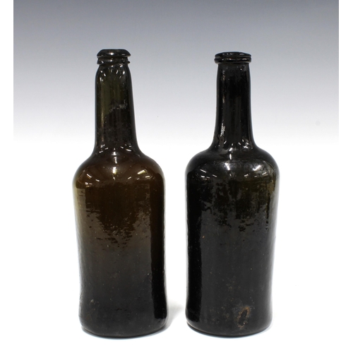 101 - Two early 19th century dark green glass wine bottles, 26cm (2)