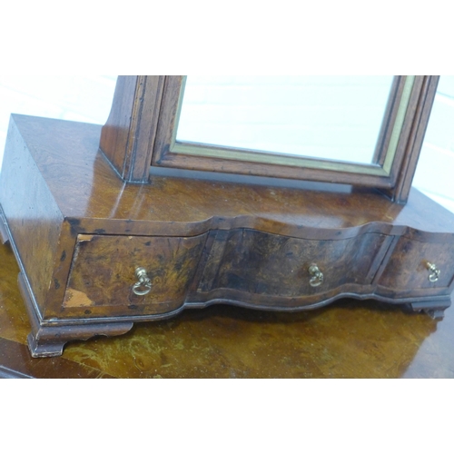 206 - Walnut dressing table mirror with serpentine base, 50 x 71 x 21cm.