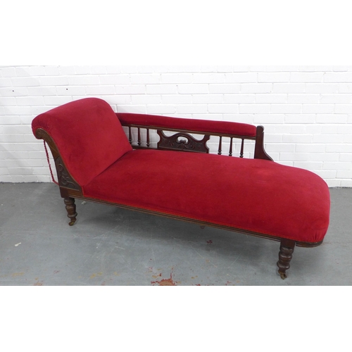 219 - Late 19th century red velvet upholstered chaise longue with carved back rail, one caster missing, 17... 