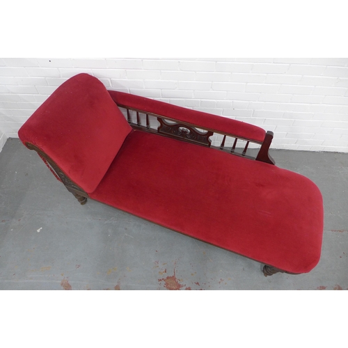 219 - Late 19th century red velvet upholstered chaise longue with carved back rail, one caster missing, 17... 