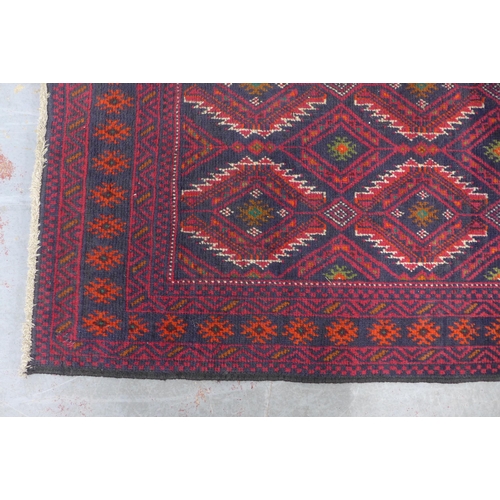 229 - Afghan rug with red field and geometric pattern, 175 x 98cm