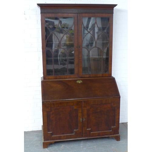 252 - Georgian mahogany bureau bookcase, the projecting cornice with a blind fret frieze over a pair of as... 