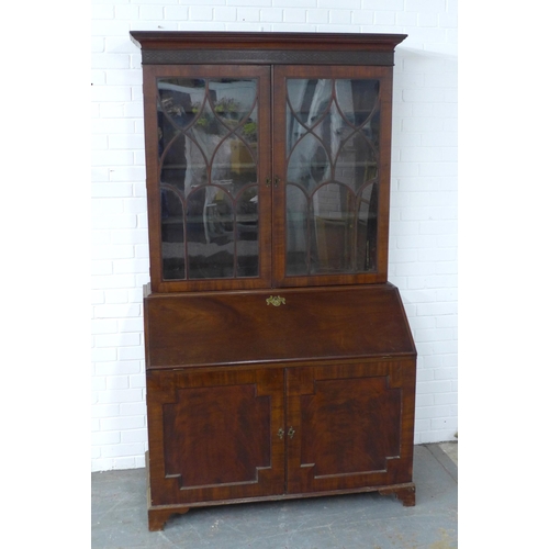 252 - Georgian mahogany bureau bookcase, the projecting cornice with a blind fret frieze over a pair of as... 