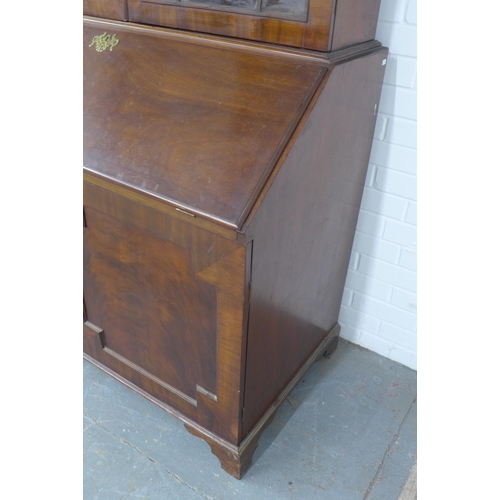 252 - Georgian mahogany bureau bookcase, the projecting cornice with a blind fret frieze over a pair of as... 