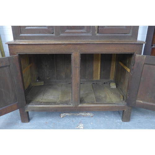 253 - Welsh oak Tridarn with canopied upper section, above three small doors, the base with a pair of pane... 