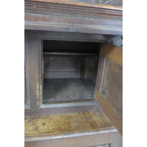 253 - Welsh oak Tridarn with canopied upper section, above three small doors, the base with a pair of pane... 