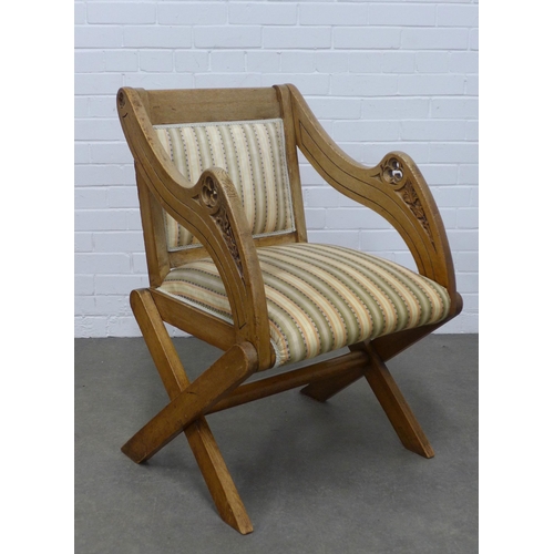 259 - Oak Glastonbury chair with carved arms, upholstered back and seat,  64 x 90 x 52cm.