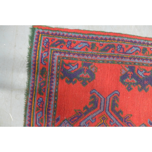 288 - Turkish rug with red field, 214 x 127cm.