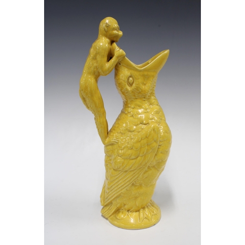 316 - Victorian style moulded jug, yellow glazed, in the form of a bird with open mouth and with a monkey ... 