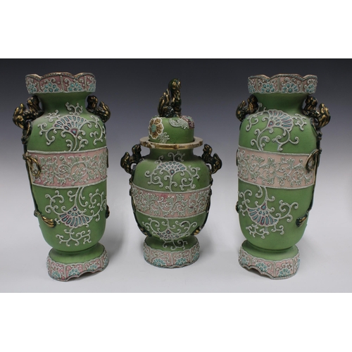 342 - Japanese Moriage garniture of vases with green and pink ground, with foo dog handles and painted fig... 