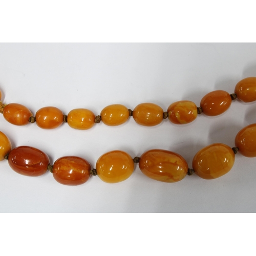 35 - A strand of vintage butterscotch amber beads, largest bead 1.7cm