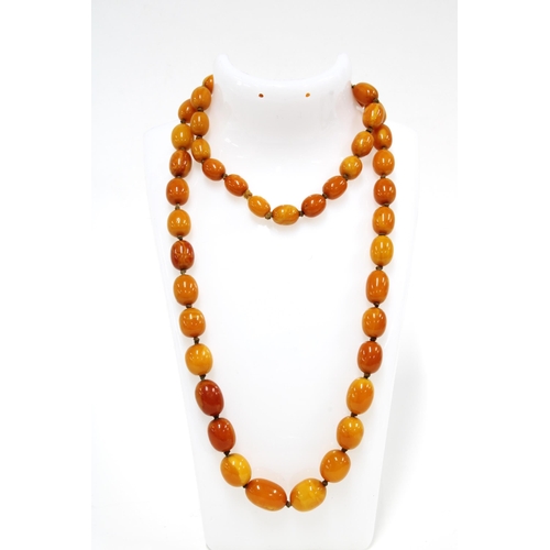 35 - A strand of vintage butterscotch amber beads, largest bead 1.7cm