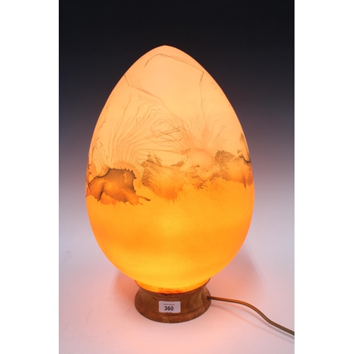 360 - An opaque glass egg shaped and with painted decoration, table lamp, on a wooden base, 46cm