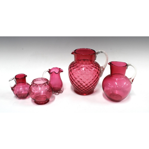 365 - Two cranberry glass jugs, taller 18cm, together with two small jugs and a vase (5)