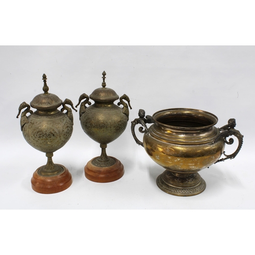 374 - A pair of  brass urns with covers and elephant handles, on wooden bases, 38cm together with a pedest... 