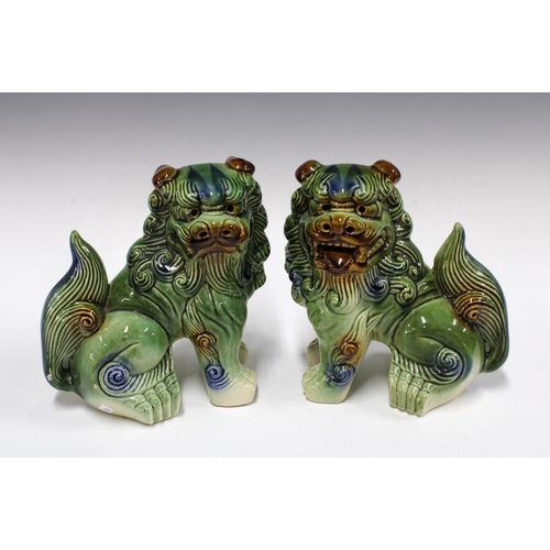 378 - A pair of pottery Foo dogs / lions, 22cm (2)