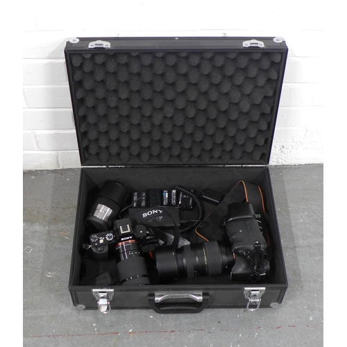 401 - Metal case containing a Sony A7R III and a Sony A77II, one extra lens and batteries, includes lenses... 