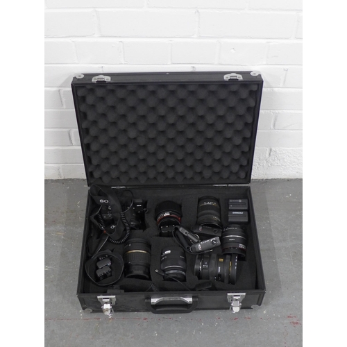 402 - Metal case containing a Sony A6000 and six lenses, batteries etc, lenses include Sigma 10-20mm / 1:3... 