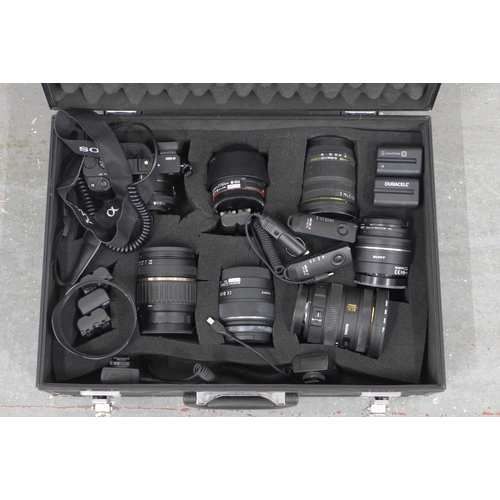 402 - Metal case containing a Sony A6000 and six lenses, batteries etc, lenses include Sigma 10-20mm / 1:3... 