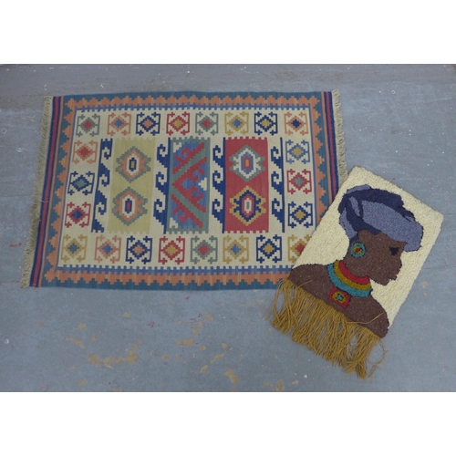 404 - Small kilim rug, 90 x 62cm, together with a wall hanging of a woman in a head wrap (2)