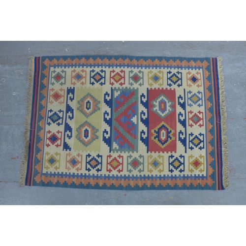 404 - Small kilim rug, 90 x 62cm, together with a wall hanging of a woman in a head wrap (2)