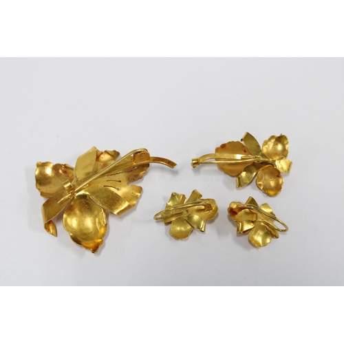 44 - Yellow metal orchid brooches and pair of matching earrings, each set with a single pearl, the larger... 