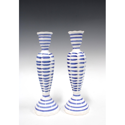 136 - Pair of Designers Guild blue and white pottery candlesticks, 27cm (2)