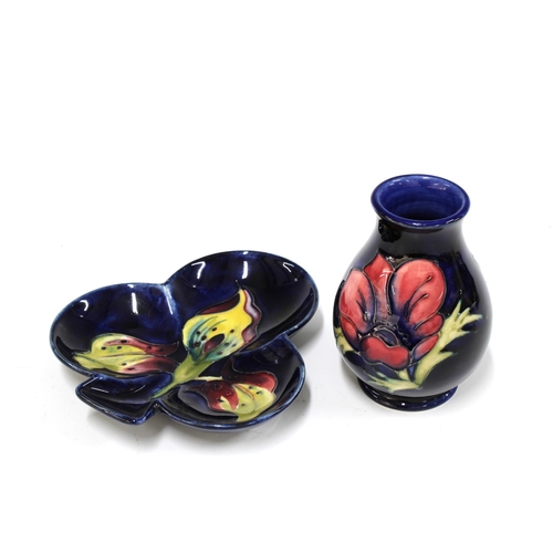 141 - Moorcroft Pottery dark blue anemone vase, 10cm, together with a Moorcroft dark blue arum lily clover... 