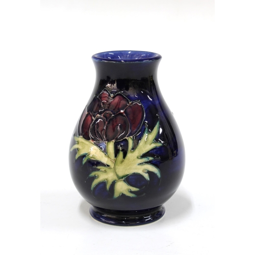 141 - Moorcroft Pottery dark blue anemone vase, 10cm, together with a Moorcroft dark blue arum lily clover... 