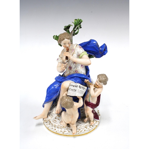 143 - Porcelain figure group representing Music with a female musician and two cherubs, on a circular gilt... 