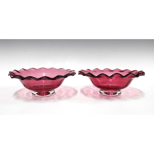 169 - Pair of cranberry glass bowls with frilled rims, and clear glass footrims, 23 x 18cm (2)