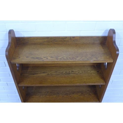 266 - A Liberty and Co Arts and Crafts oak open bookcase with plaque to the back, 83 x 117 x 25cm.