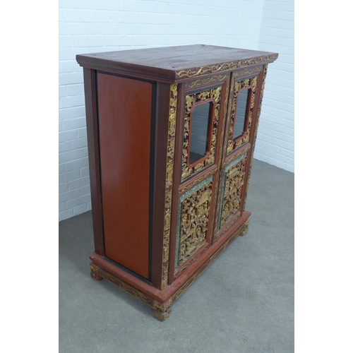 277 - Chinese giltwood and red lacquered cabinet, two doors with shelved interior,  x 126 x 54cm.