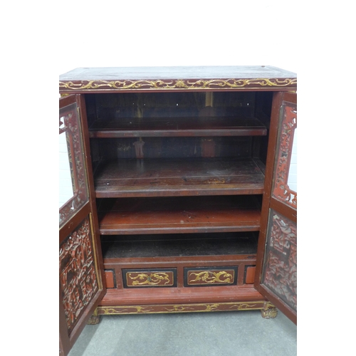 277 - Chinese giltwood and red lacquered cabinet, two doors with shelved interior,  x 126 x 54cm.