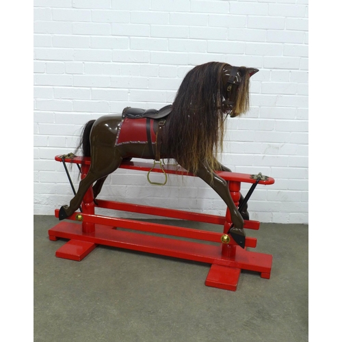 286 - Childs rocking horse, on a red painted trestle rocking base, 122 x 100cm.