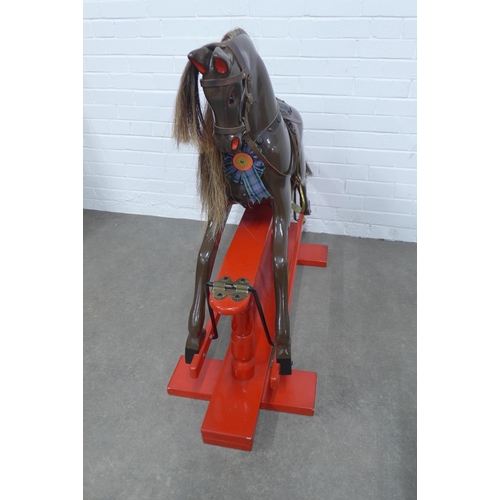 286 - Childs rocking horse, on a red painted trestle rocking base, 122 x 100cm.