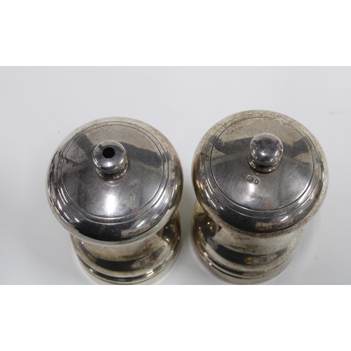 37 - A pair of Mappin & Webb silver pepper grinders, London 1994, 8cm (2)