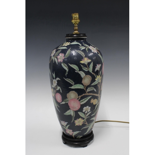 427 - Chinoiserie table lamp, with plums and foliage on a dark navy field, 52cm