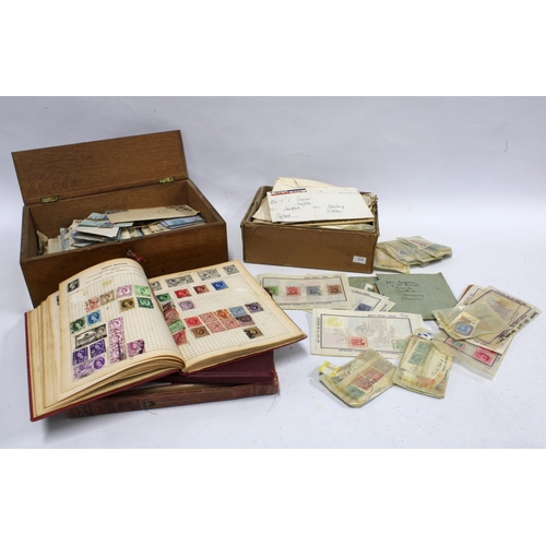 432 - Three stamp albums with stamps, together with a wooden box of stamps on envelopes and a cardboard bo... 