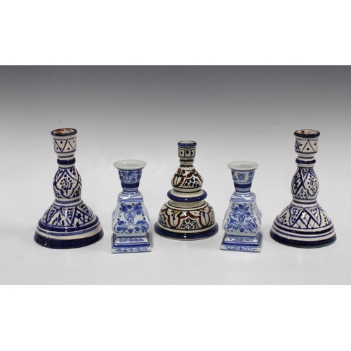 441 - Three pottery candlesticks, tallest 17cm, together with two blue and white ceramic candlesticks (5)