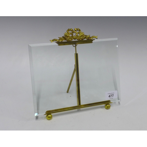 477 - Rectangular glass frame with a gilt metal ribbon surmount, on ball feet, with an easel strut back,  ... 