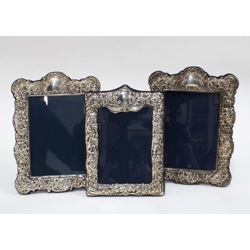 51 - Pair of white metal photograph frames, 15 x 21cm, together with a Sheffield silver photograph frame ... 