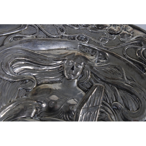 59 - An Art Nouveau silver backed hand mirror, Chester 1906, 28cm