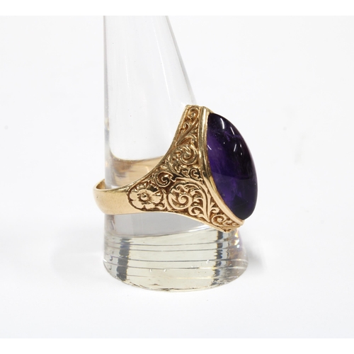 70 - A vintage 9ct gold ring with a amethyst cabochon in a floral engraved setting, London 1973, size T