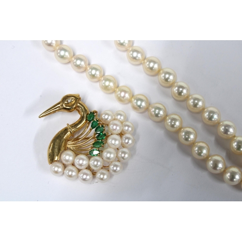 97 - 14ct gold swan brooch set with pearls, emeralds and a diamond, stamped 585 together with a strand of... 