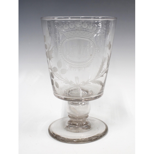 128 - A large early 19th century goblet with a 1787 coin in the stem, with etched monogram J.M.C 1830 surr... 