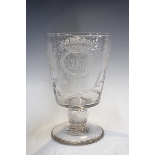 128 - A large early 19th century goblet with a 1787 coin in the stem, with etched monogram J.M.C 1830 surr... 