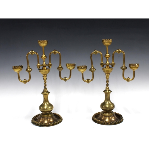 147 - Pair of Gothic style brass candelabras, 26 x 35cm