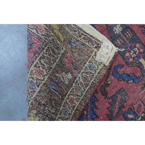 273 - Persian rug with blue and red field, 207 x 110cm.