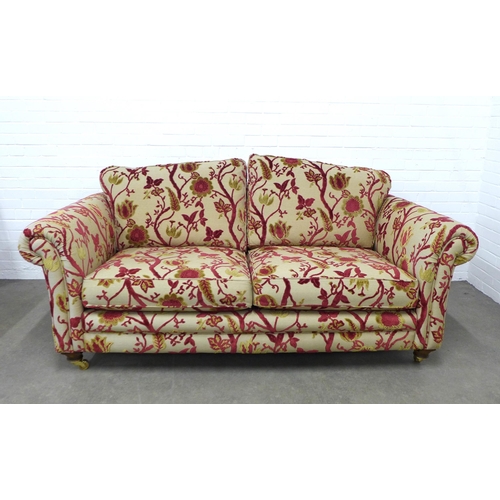 278 - Modern two seater scroll arm sofa with floral upholstery, wooden legs with brass caps and castors 20... 